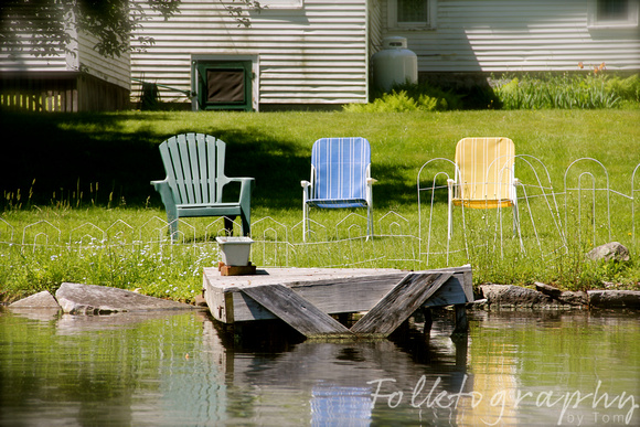 3 chairs by the water